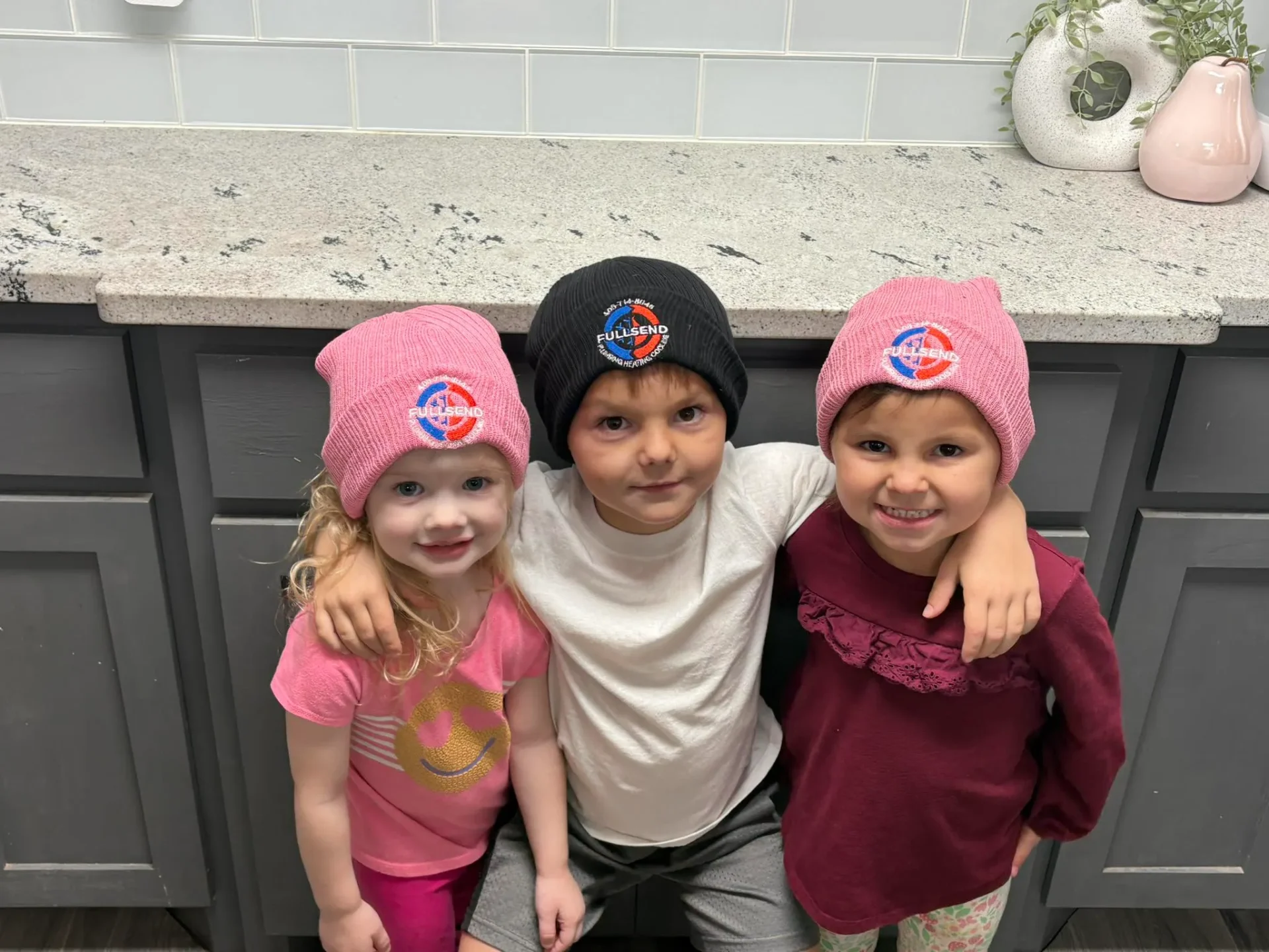 Full Send Plumbing Heating and Cooling family - kids wearing branded beanies