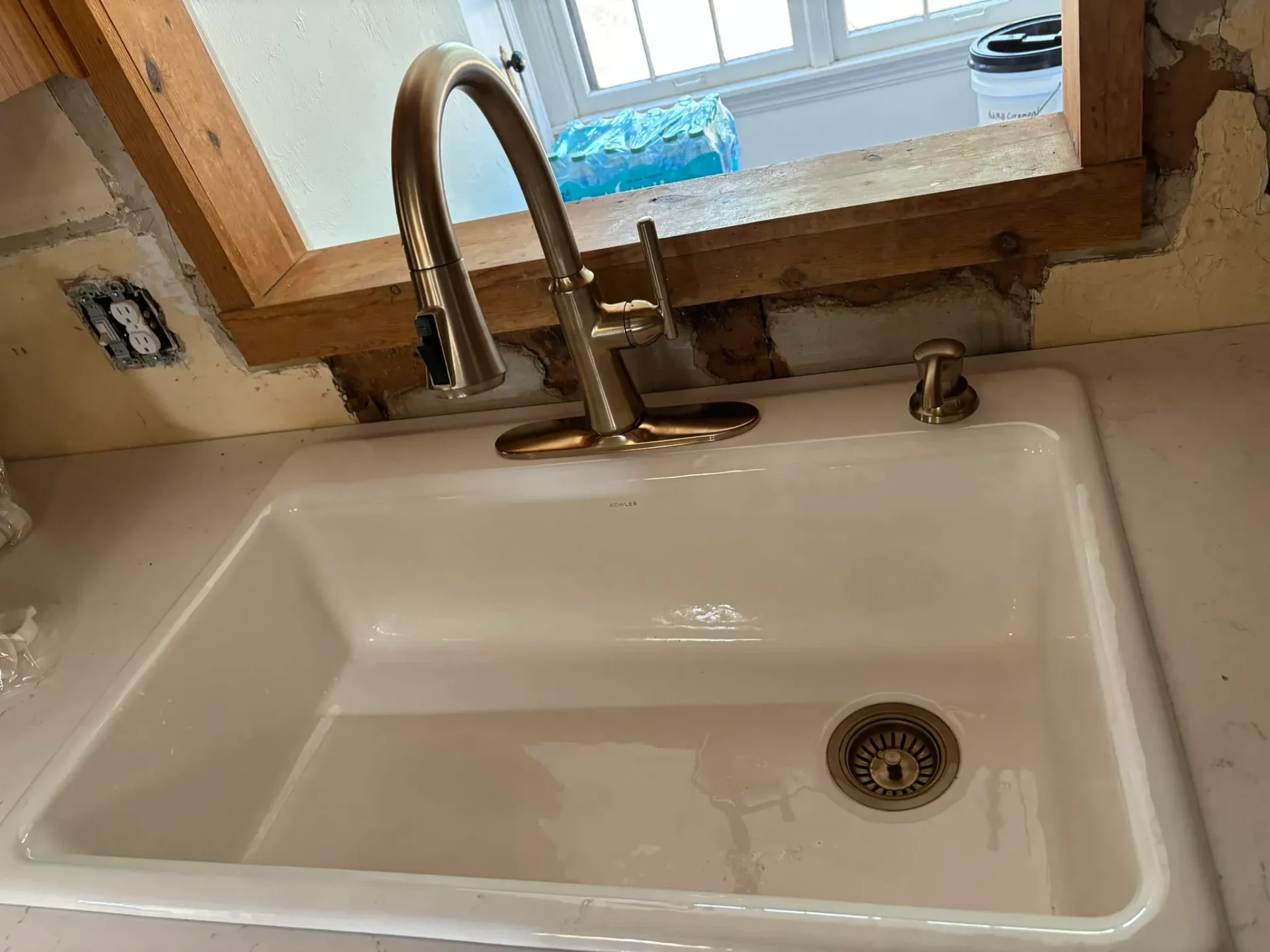 New Kohler sink with bronze faucet installed by Full Send Plumbing