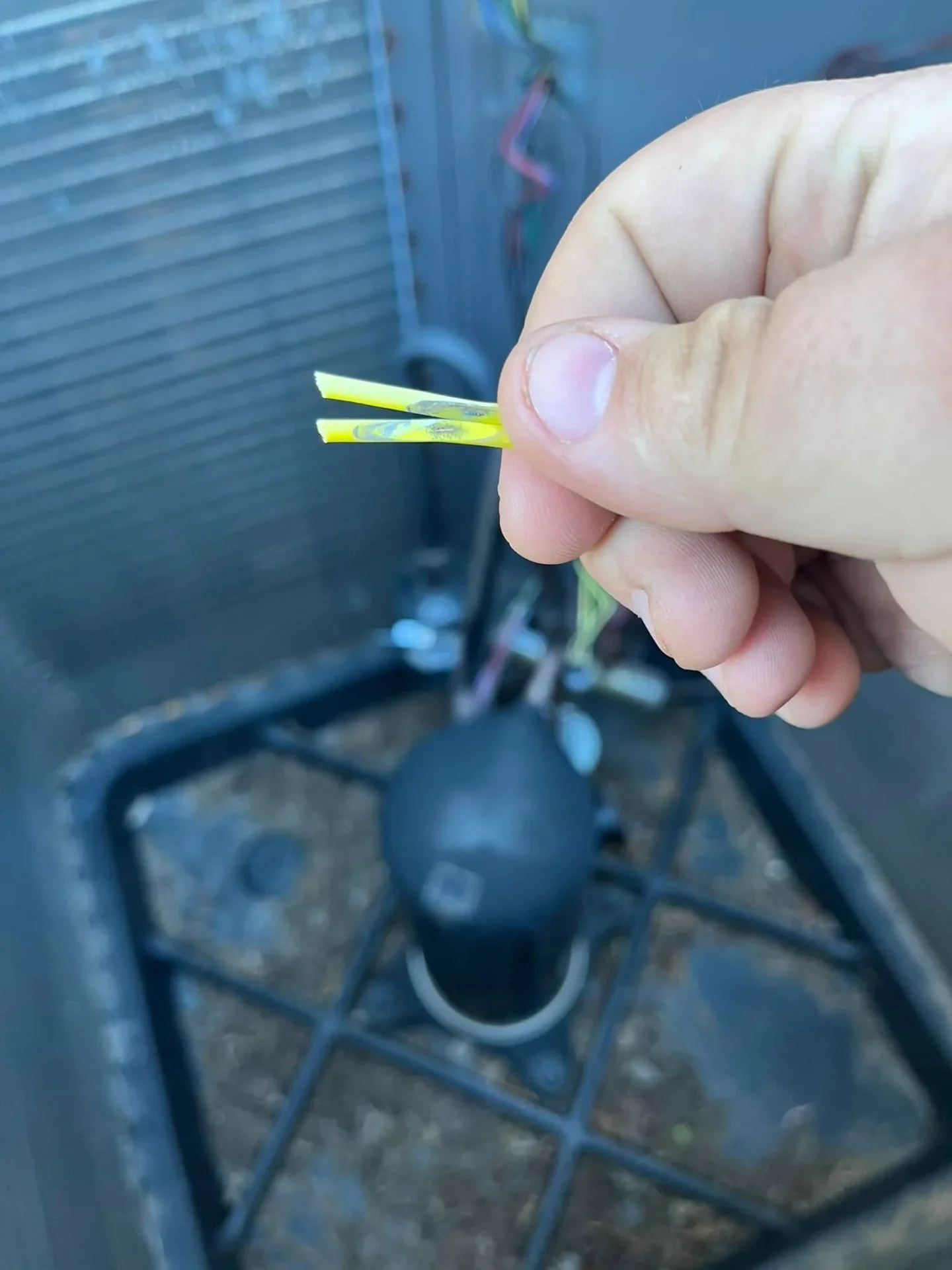 Technician performing wire repair on AC unit in Perkins OK